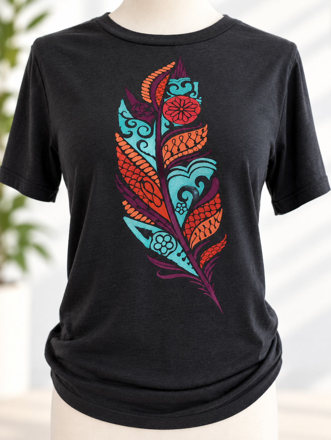 Black t-shirt with colorful hand-painted feather design