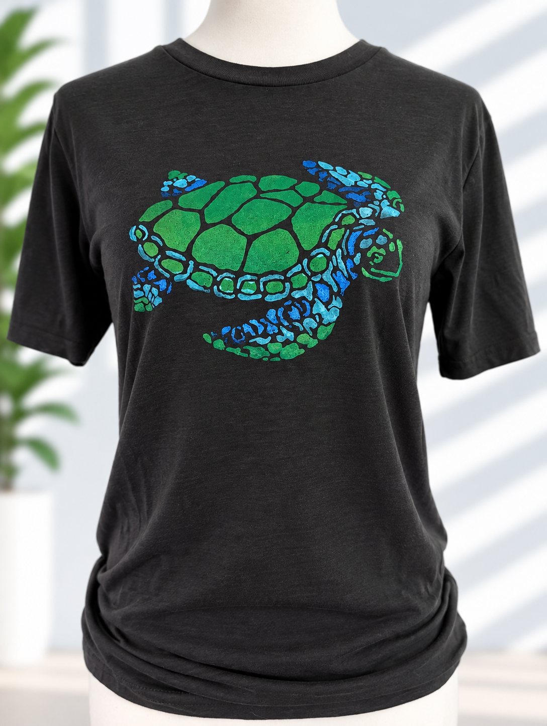 Black t-shirt with hand-painted sea turtle design in green and blue tones