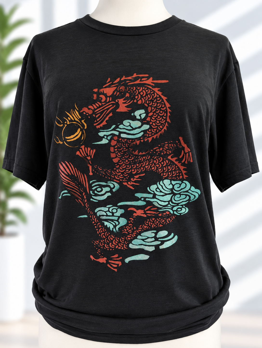 Black t-shirt with hand-painted dragon design in red and teal tones with gold accent