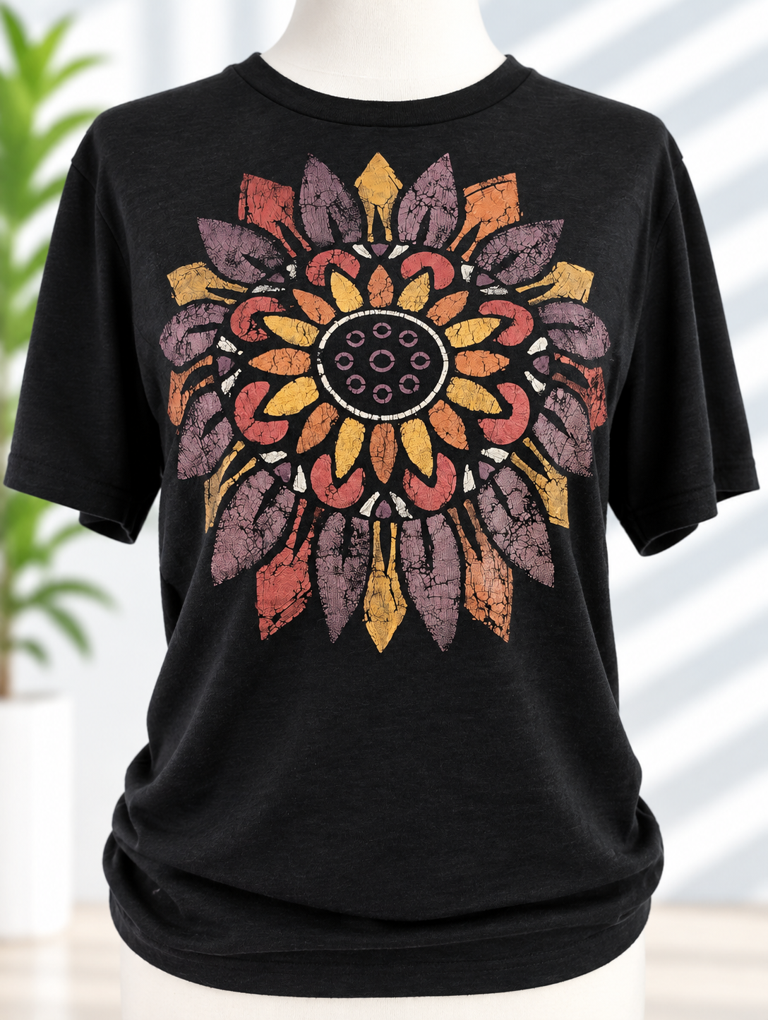 Black t-shirt with hand-painted distressed sunflower mandala design in purple, coral, and gold