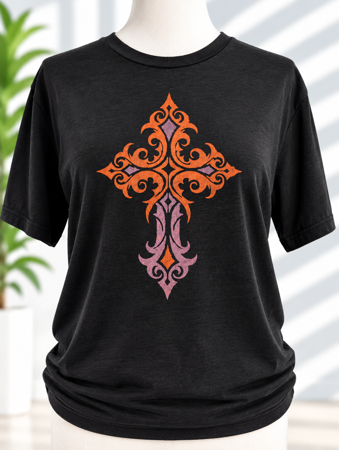 Black t-shirt with hand-painted ornamental cross design in orange and pink tones
