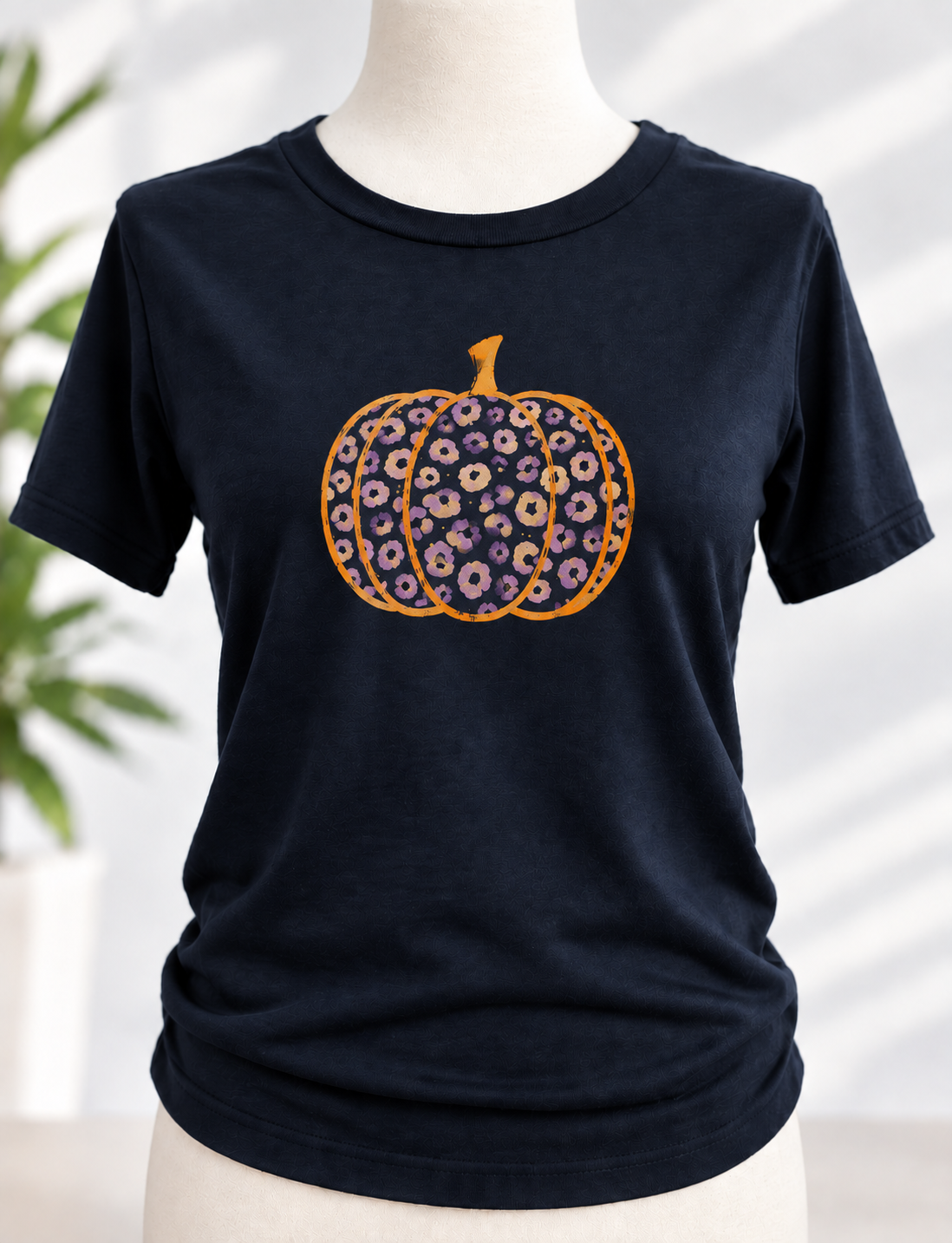 Navy t-shirt with hand-painted leopard print pumpkin design in orange and purple tones